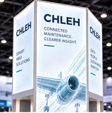 Tall backlit aviation brand tower with illuminated aircraft graphics and branding on multiple faces