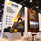 Sports trade show booth with a wood slat feature wall, integrated screen, outdoor graphics and meeting furniture